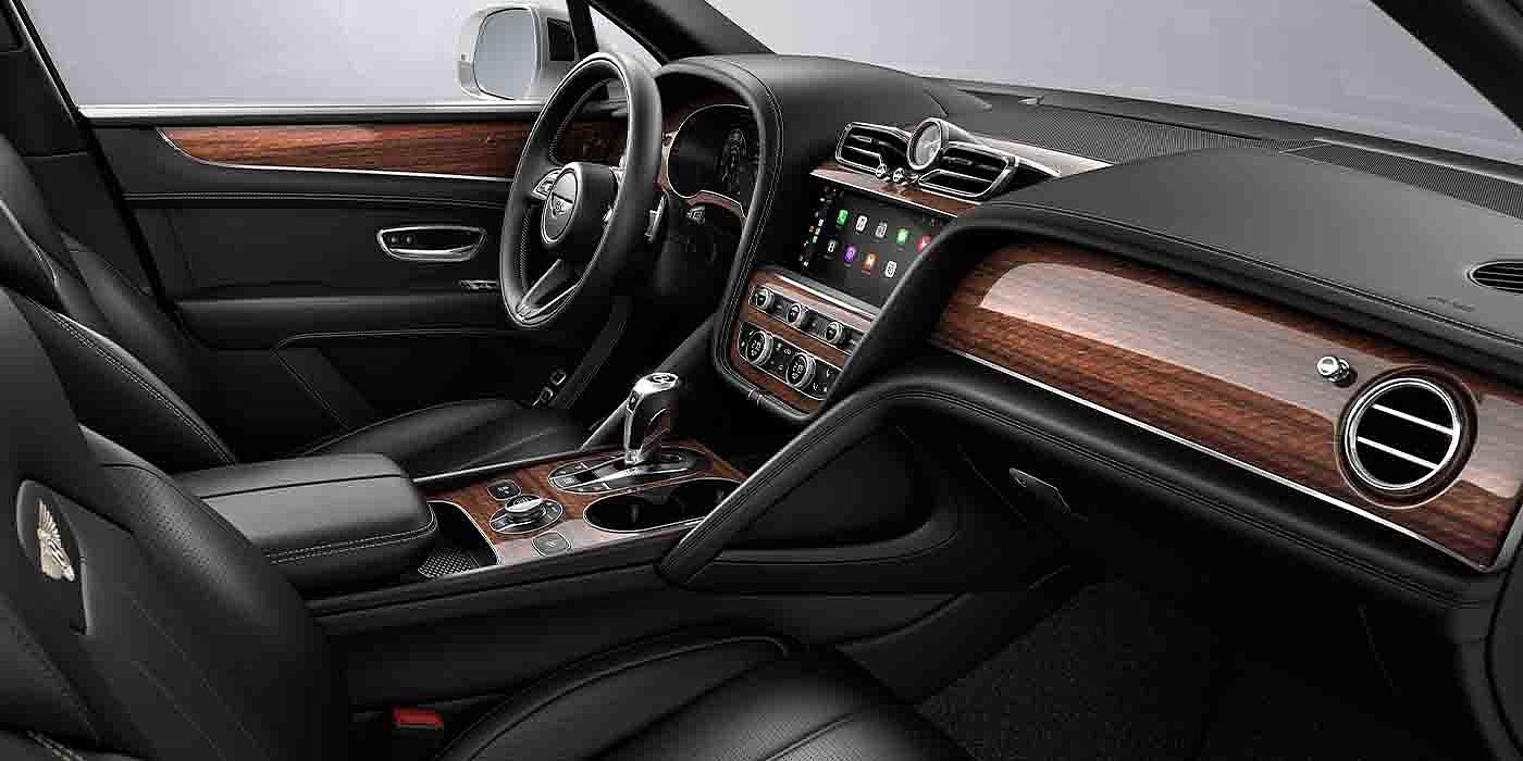 Bentley Beijing - Wukesong Bentley Bentayga EWB interior with a Crown Cut Walnut veneer, view from the passenger seat over looking the driver's seat.